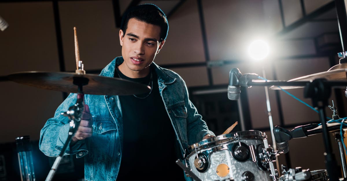 Young Black male Drummer playing the drums