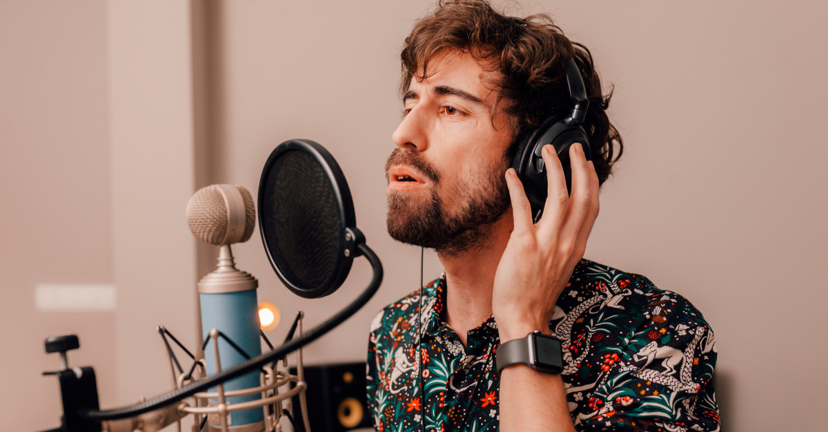 Male musician singing into microphone