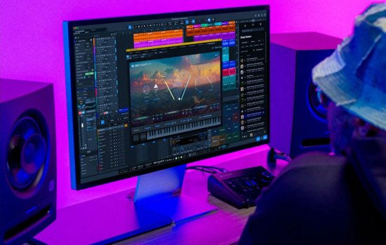 PreSonus Studio One running on a screen in front of a man in a bucket hat